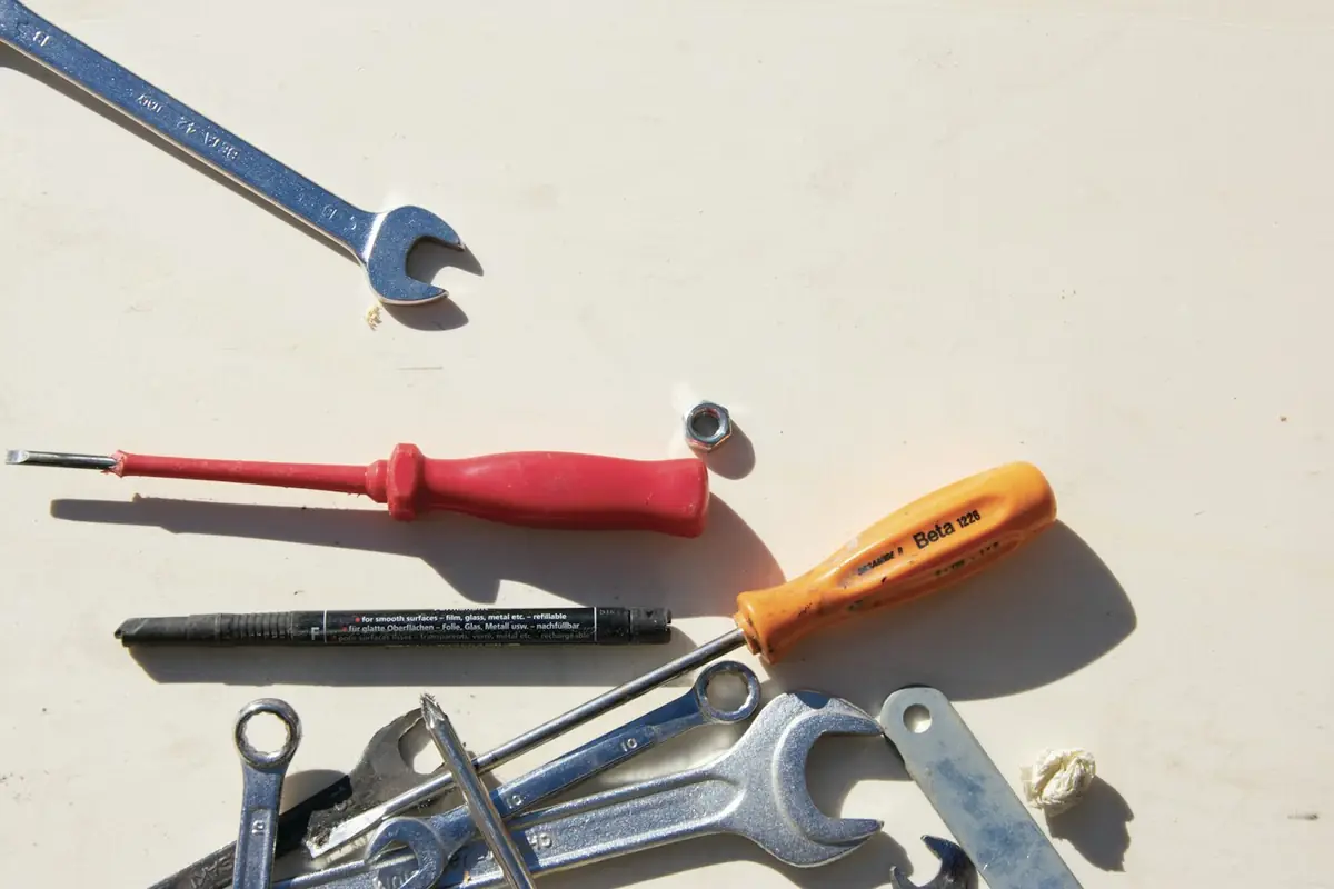 Wrenches and screwdrivers laid out on a work surface